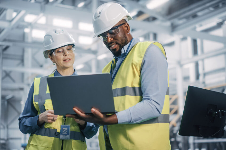 A construction project manager and construction prhect executive using RedTeam's solutions on a jobsite